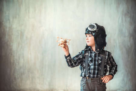 Little boy with wooden airplaneの写真素材