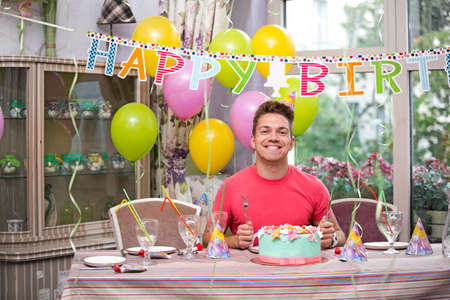 Joyful man at a birthday partyの写真素材