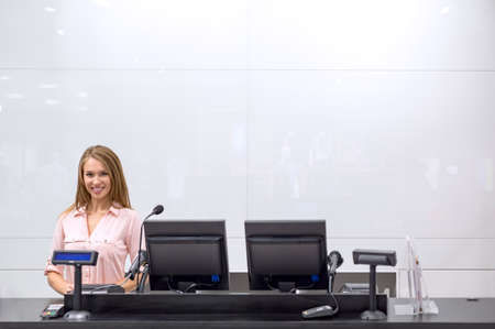 Young girl behind the counterの写真素材