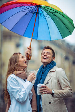 Smiling couple with an umbrellaの写真素材