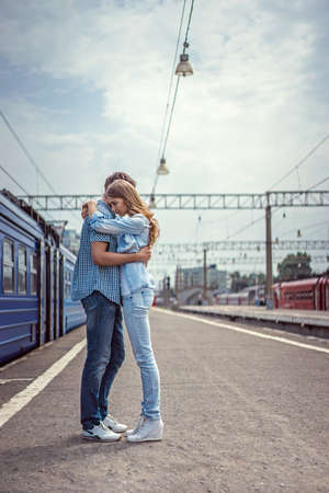 Couple hugging in a train stationの写真素材