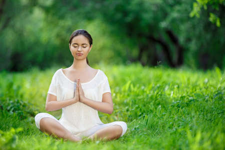 Young girl doing yoga outdoorsの写真素材