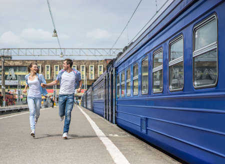 Running couple at the train stationの写真素材