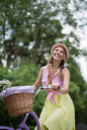 Beautiful young girl with a bicycleの写真素材