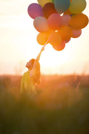 Little girl with balloons outdoorsの写真素材