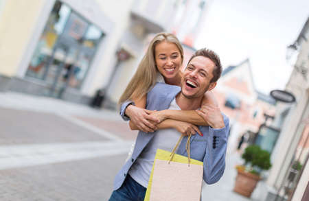 Smiling couple with shopping bags outdoorsの写真素材