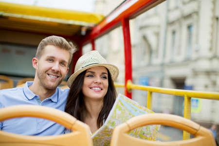 Young couple with a map outdoorsの写真素材