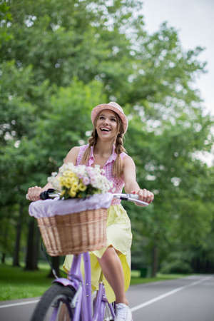 Young girl on a bicycle in the parkの写真素材