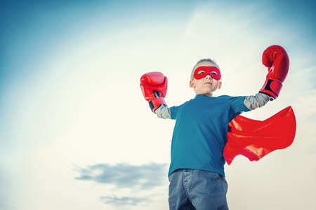 Little boy with boxing gloves outdoorsの写真素材