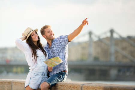 Young couple with a map on the streetの写真素材