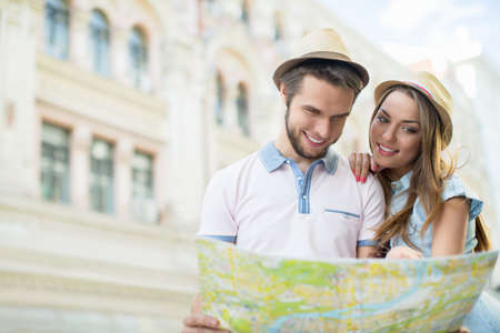 Attractive couple with a map on the streetの写真素材