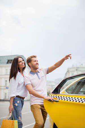 Smiling couple with taxiの写真素材