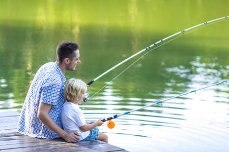 Dad and son fishing outdoorsの写真素材