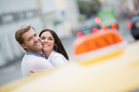 Young couple with a taxiの写真素材
