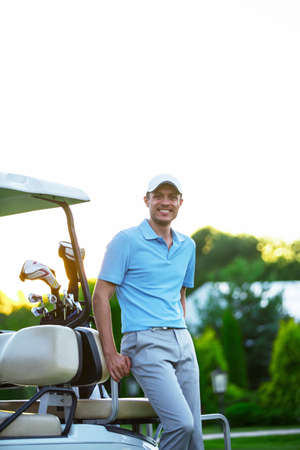 Young man in golf cartsの写真素材