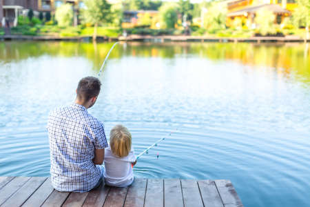 Father and son fishing on the pier