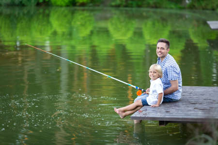 Happy dad and son fishingの写真素材