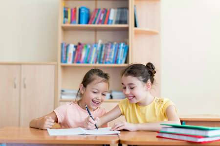 Smiling girl at a desk at school