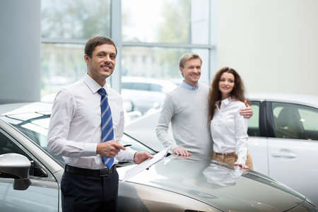 Couple buying a car in autocenter