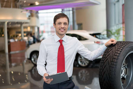 Young salesman with rubber in serviceの写真素材