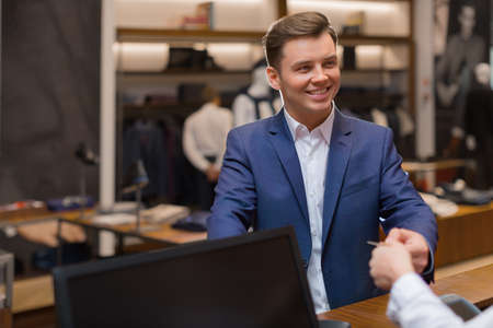 Young businessman at checkoutの写真素材