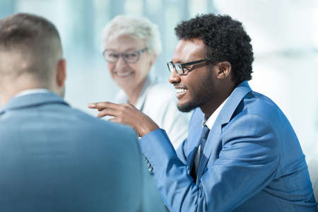 Smiling business people at meeting in officeの写真素材