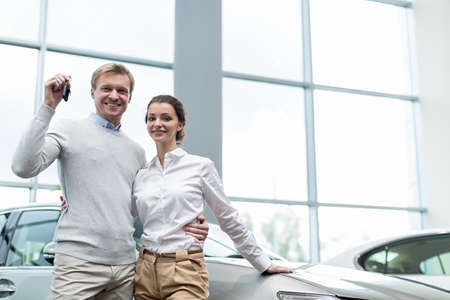 Young couple with car keysの写真素材