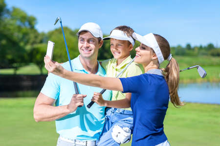 Smiling family making selfie outdoorsの写真素材