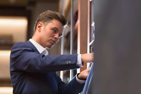 Young businessman in storeの写真素材