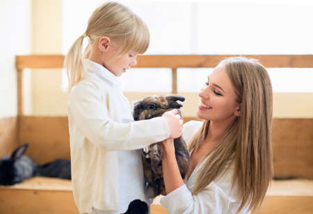 Mother and daughter with rabbitの写真素材