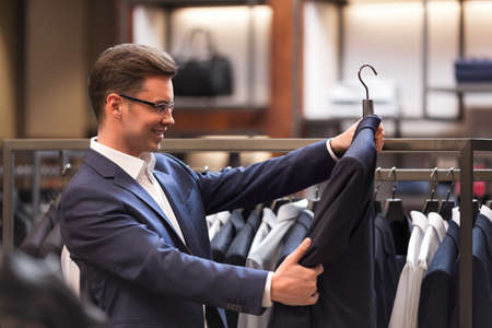 Smiling businessman in suit in storeの写真素材