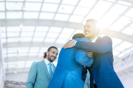 Smiling businessmen in officeの写真素材