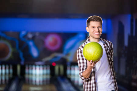 Smiling man with bowling ballの写真素材