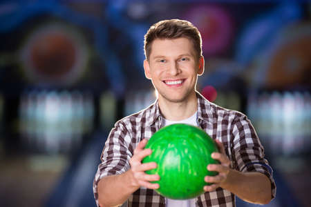 Smiling man with bowling ballの写真素材