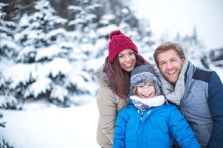 Family at winter forestの写真素材