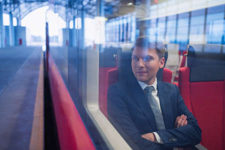 Young businessman in a trainの写真素材