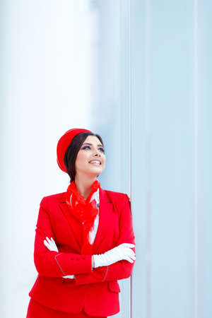 Young stewardess in a form at airportの写真素材