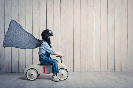 Smiling boy with car in studioの写真素材