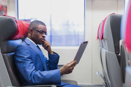 Young businessman in a trainの写真素材