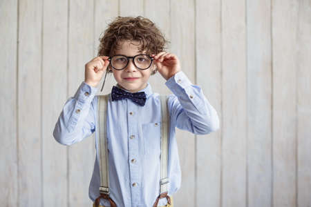 Smiling boy in glasses indoors