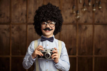 Little boy with a retro cameraの写真素材