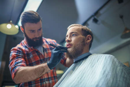 Customer and hairdresser in barber shop