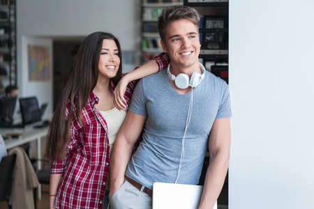 Smiling couple in libraryの写真素材