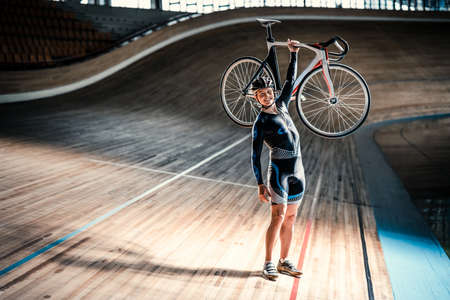 Young athlete with bicycle at velodromeの写真素材
