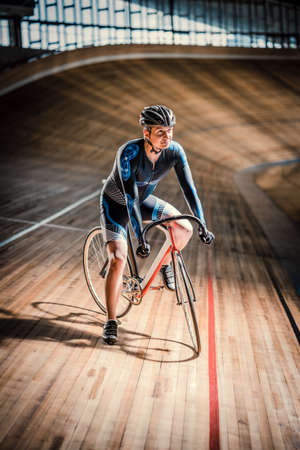 Athlete with a bicycle at velodromeの写真素材