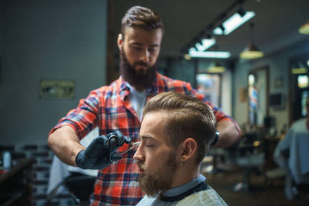 Working man with customer in barber shop