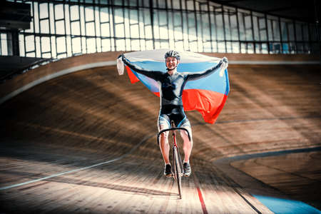 Young cyclist on a cycle trackの写真素材