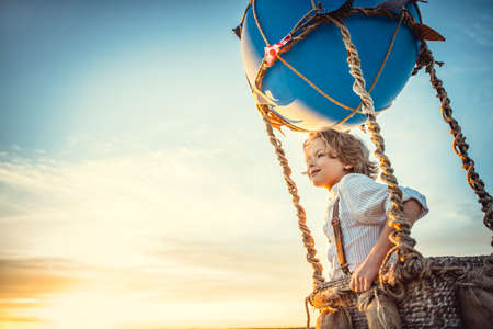 Smiling boy with a spyglass in the skyの写真素材