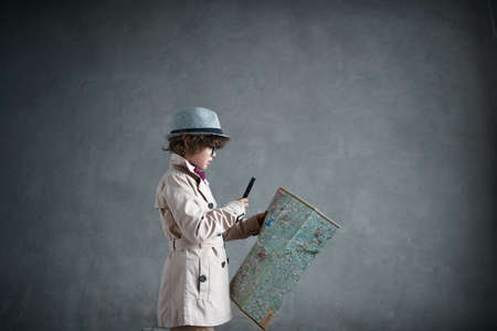 Little detective with a mapの写真素材