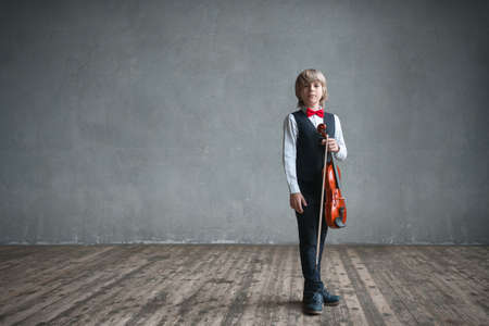 Child with violin in studio